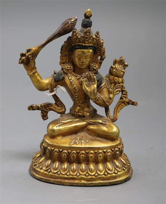 A Sino-Tibetan gilt bronze figure of a deity
